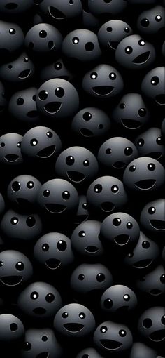 many black balls with faces and eyes are shown in the dark background, as if they were floating or floating