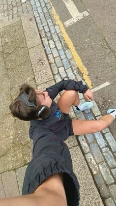 a person laying on the ground with headphones