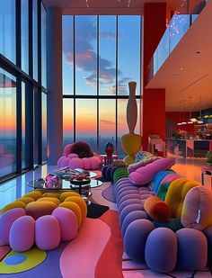 a living room filled with lots of furniture next to large windows at sunset or dawn