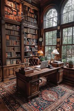 a large desk with a laptop on top of it in front of two huge windows