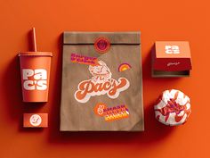 a bag, cup and donut on an orange background