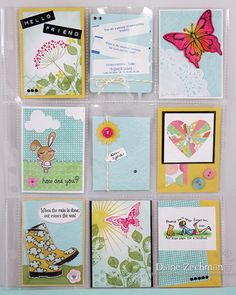 many different cards are arranged in a clear holder on the wall with buttons and magnets