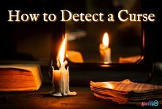 two lit candles sitting next to an open book with the words how to defect a curse