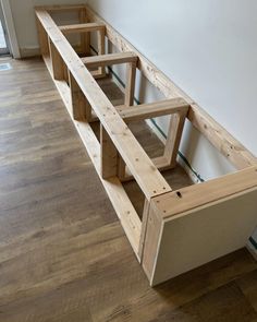 a wooden shelf sitting on top of a hard wood floor