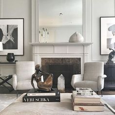 a living room filled with furniture and a fire place in front of a white fireplace