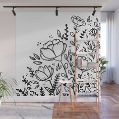 the wall mural is decorated with black and white flowers, leaves and plants on it