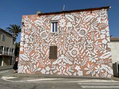 a building with white flowers painted on it