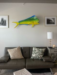 a living room filled with furniture and pictures hanging on the wall above it's couch