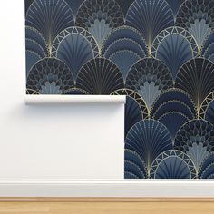 an art deco wallpaper with blue fan design on the back and gold foiling