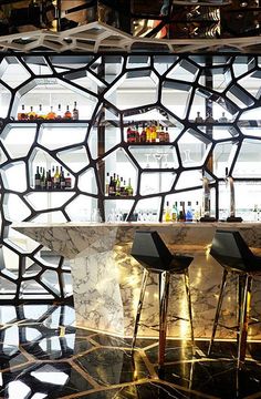 two bar stools sitting in front of a marble counter