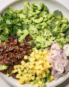 broccoli, onions, and other vegetables on a plate