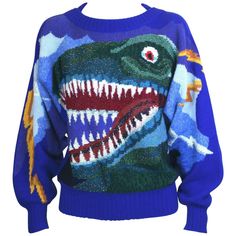 Wonderful Krizia Collectible Dinosaur Sweater, Amazing intarsia design with dozens of different yarns (metallic, matte, fuzzy) combine to make this ferocious graphic of T Rex with golden lighting bolds running down the deep bat wing sleeves, Wool knit base with a bevy a different yarns used to create this wonderful knitted "painting". Wonderfully collectible piece from the famed Krizia Animal Series. 1980's Italy. Size 40 Italian. 70% wool, 20% angora, 10% rayon. Excellent condition. L Knitted Bat Wing Sweater Pattern, Fun Sweaters Knit, Unif Pixie Sweater, Dinosaur Sweater Women, Dinosaur Sweater Vest, Cute Dino Sweater, Knit Kitsch Sweater Pattern, Dinosaur Knitting Sweater, Mf Doom Sweater Knit