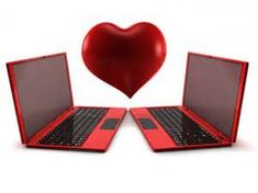 two red laptops with a heart shaped object in the background