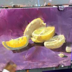 an oil painting of lemons on a purple surface with one sliced up and the other half peeled