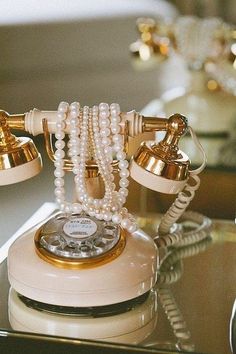 an old fashioned phone with pearls on it