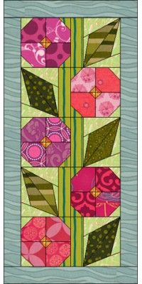 a quilted wall hanging with pink flowers and green leaves on the bottom, along with an aqua blue background