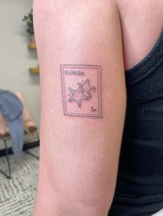 a woman's arm with a stamp on it that says florida and has a star in the middle