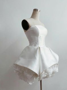 a white dress on a mannequin with flowers