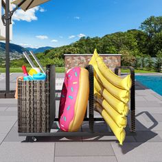 an umbrella and some inflatable toys near a swimming pool