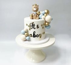 a baby shower cake decorated with teddy bears and balloons on a white pedestal in front of a gray background