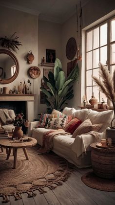 a living room filled with furniture and a fire place in front of a large window