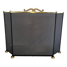 a large metal fireplace screen with wheels on the sides and a gold handle at the top