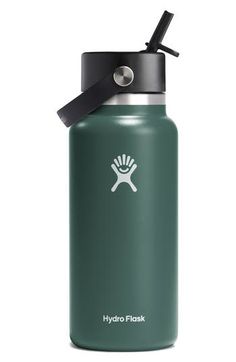 the hydro flask water bottle is green and has a black lid with a white logo on it