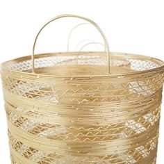 a round basket with metal handles on a white background