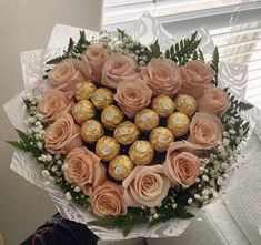 a bouquet of roses and chocolates in the shape of a heart