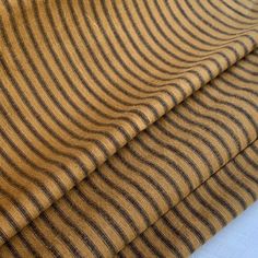 two brown and black striped fabric on top of each other in different sizes, shapes and colors