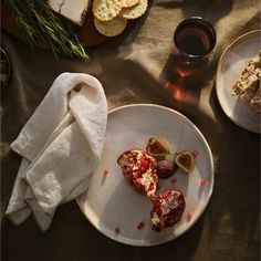 a plate with some food on it next to other plates and utensils,