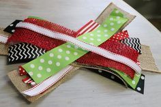 the ribbon is wrapped in burlap and decorated with red, white, and green polka dots