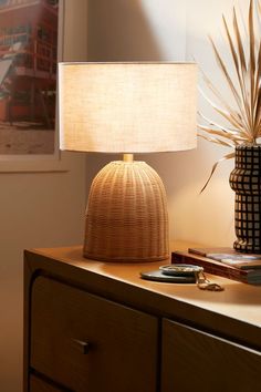 a table lamp sitting on top of a wooden dresser