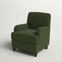 a green chair sitting on top of a white floor next to a wooden legrest