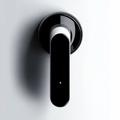 an electronic device mounted on the wall with a circular button in it's center