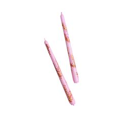 two pink toothbrushes with gold flecks on them sitting next to each other