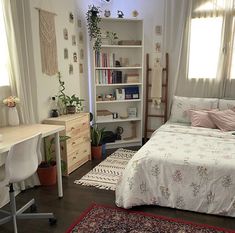 a bedroom with a bed, desk and bookshelf