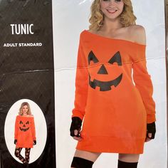 a woman in an orange halloween costume standing next to a cardboard box with her hands on her hips