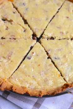 a pie sitting on top of a blue and white checkered table cloth