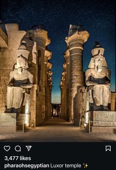 an image of some statues in the night sky