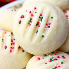 some cookies with sprinkles are on a plate