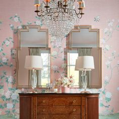 a dresser with two lamps and a chandelier hanging from it's side