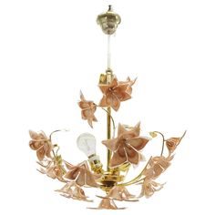 a gold chandelier with flowers on it