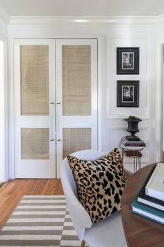 a living room filled with furniture and pictures on the wall