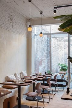 an empty restaurant with wooden tables and chairs