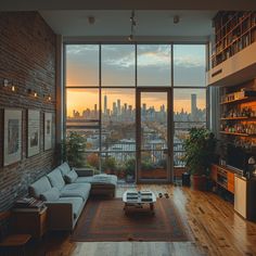 a living room filled with furniture and a large window overlooking the city at sunset or dawn