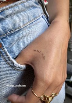 a person with a small tattoo on their left hand and the word love is written in cursive writing