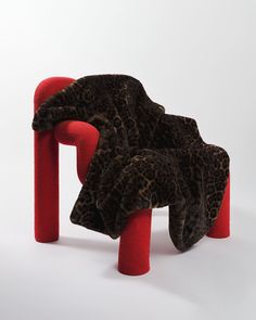 an animal print chair with two red legs