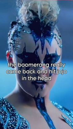 a woman with her face painted in blue and black, has the words'the boomerang really came back and hit jojo in the head