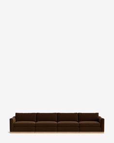 a brown couch sitting in front of a white wall